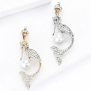 Elegant mermaid earrings with sparkling rhinestones and pearls on a white geometric base