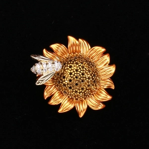 Detail of sunflower bee brooch with golden petals and sparkling rhinestone bee accents