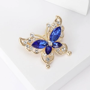 Detail view of butterfly brooch with blue marquise gemstones and small clear rhinestones