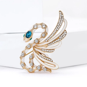 Exquisite gold swan brooch with white enamel, blue gemstone and sparkling rhinestones