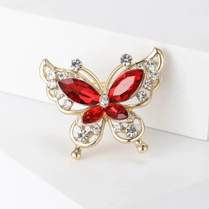 Detail of butterfly brooch with red marquise rhinestones and gold alloy frame