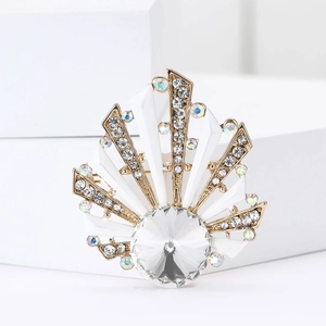 Macro detail of a shell-shaped alloy brooch with rhinestones and a central crystal inlay