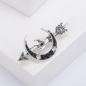 Vintage silver crescent moon and arrow brooch with blue crystals and palm eye detail