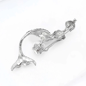 Detail view of silver mermaid brooch back showing S925 hallmark and white pearl accent