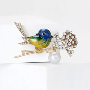 Artistic bird brooch with colorful enamel, sparkling rhinestones and a large white pearl drop