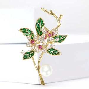 Luxurious gold floral branch brooch with green leaves, crystals and a large white pearl