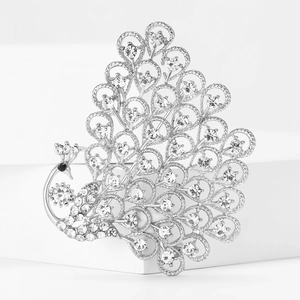 Macro view of crystal peacock brooch with silver alloy details and pavé set rhinestones