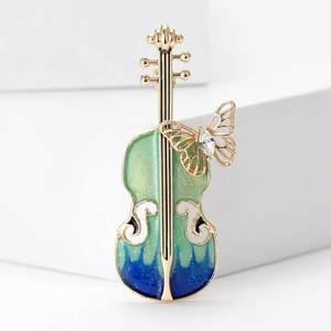 Broche violon dorée avec papillon en émail bleu sarcelle et cristal étincelant