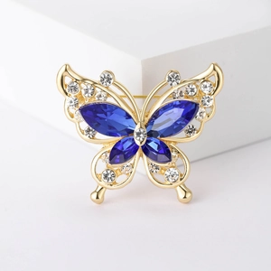 Elegant gold butterfly brooch with deep blue marquise crystals and sparkling clear diamonds