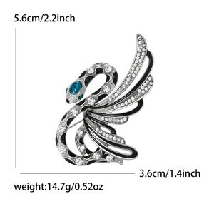 Artistic swan brooch with sparkling rhinestones and blue gem eye in silver finish