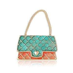 Quilted handbag brooch with green and orange enamel and golden heart charm detail