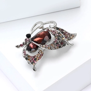 Macro shot of silver alloy butterfly brooch with multi-colored rhinestones and pear-cut stones