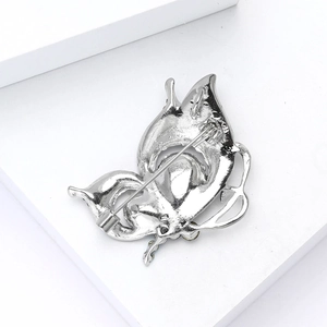 Detailed back view of a silver butterfly brooch showing the pin clasp and metal structure