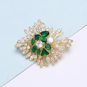 Luxurious vintage emerald flower brooch with cubic zirconia in gold plated copper base