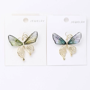 Close-up of butterfly brooch with gradient crystal wings and gold metal plating