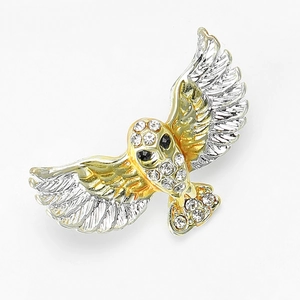 Detailed view of an owl brooch with two-tone plating and crystal-encrusted wings