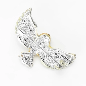 Detailed back view of eagle brooch showing silver sandblasted texture and gold plating