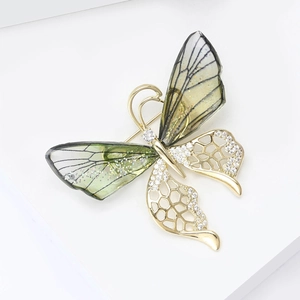 Macro view of gradient crystal butterfly brooch with golden openwork and zircon inlay