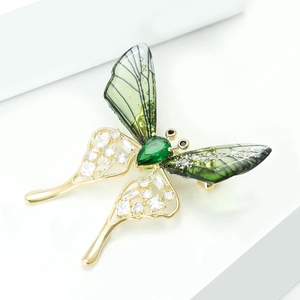 Elegant gold butterfly brooch with green zircon and translucent emerald wings