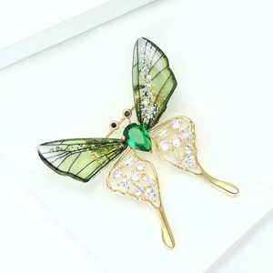 Elegant butterfly brooch in gold with green gradient wings and sparkling zircons