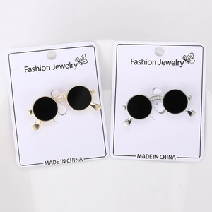 Close-up of gold and silver sunglasses brooches with sparkling rhinestone bridge detail