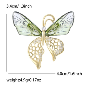 Gradient crystal butterfly brooch with golden frame and translucent green wings