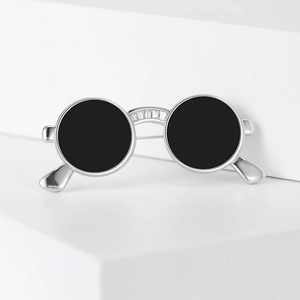 Creative vintage round sunglasses brooch with crystal accents on a white display stand