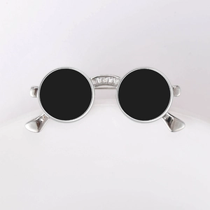 Macro view of silver sunglasses brooch with black lenses and inlaid zircon stones