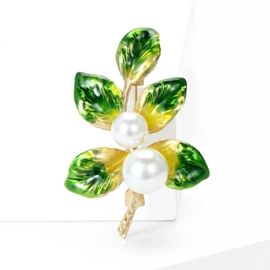 Elegant gold tree branch brooch with green enamel leaves and two white pearls