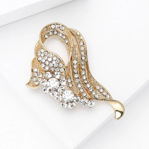 Detailed view of elegant gold rhinestone brooch with sparkling crystal floral clusters