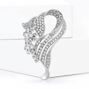 Elegant silver alloy rhinestone brooch with round and pear-shaped crystals on white blocks