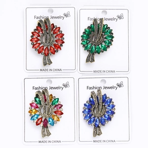 Detail view of retro marquise cut gemstone floral brooches in multiple vibrant colors