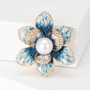 Close-up of enamel begonia brooch with blue gradient petals and center pearl
