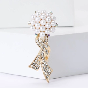 Elegant gold alloy brooch with white pearls, clear zircons, and floral ribbon design