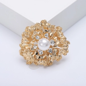 Elegant gold flower brooch with a large white pearl and sparkling crystal rhinestones