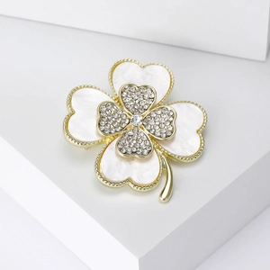 Detail of four-leaf clover brooch with mother-of-pearl inlay and sparkling crystals