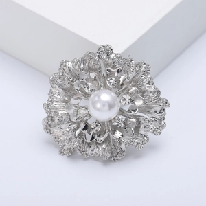 Elegant floral silver brooch with central white pearl and sparkling rhinestones