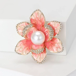 Detail of pink enamel crabapple brooch with white pearl center and shimmering crystals
