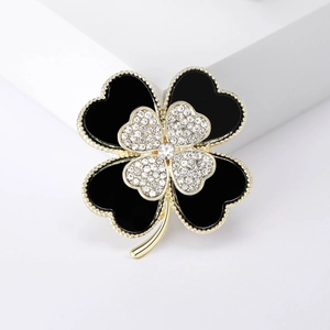 Elegant gold plated clover brooch with black enamel and sparkling rhinestones for coats