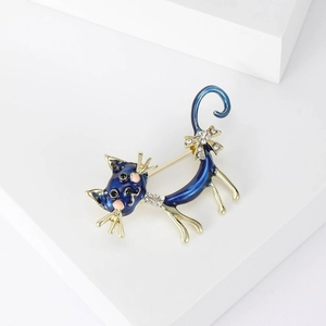 Detail of a blue enamel cat brooch featuring sparkling rhinestones and gold-plated edges