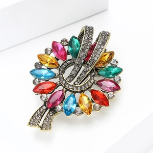 Detailed macro view of retro floral brooch with colorful marquise-cut gems and crystals