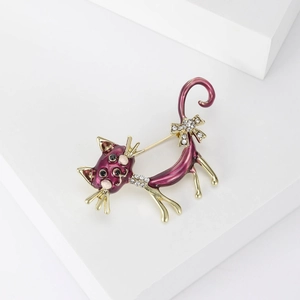 Detail of purple enamel cat brooch with white rhinestones on a white display stand