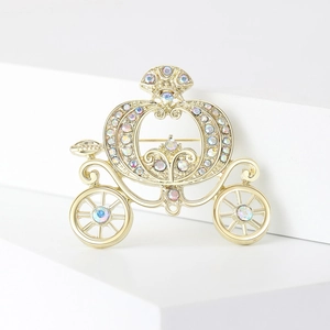 Golden pumpkin carriage brooch with sparkling AB rhinestones in a fairytale style