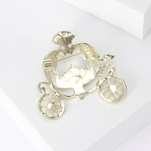 Rear view of gold pumpkin carriage brooch showing secure safety pin and hollow design