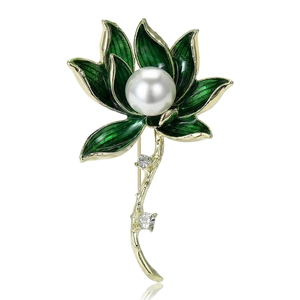 Elegant lotus flower brooch with green enamel petals and a central pearl on a white background