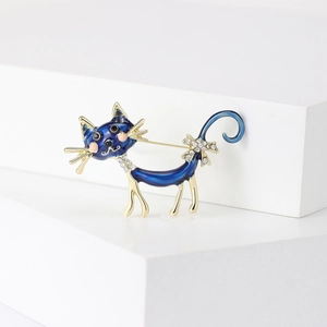 Elegant cartoon blue enamel long-tailed cat brooch with crystal bow and gold trim details