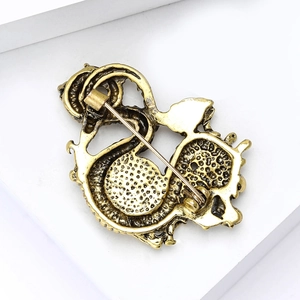 Detailed back view of vintage gold alloy dragon brooch with pin clasp and textured metal finish