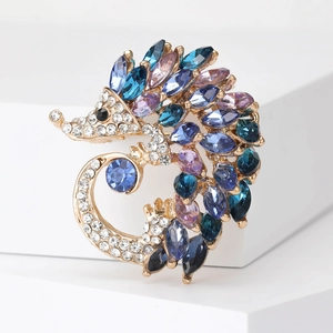 Close-up of blue and purple marquise crystals on a gold hedgehog brooch pin