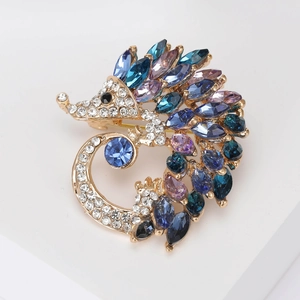 Detail of hedgehog brooch with multi-color blue and purple crystals on gold alloy
