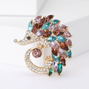 Detailed shot of gold-plated hedgehog brooch with colorful rhinestones and sparkling crystals